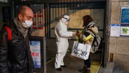 BEIJING, CHINA - JANUARY 28: A Chinese worker is dressed in a protective suit as he takes the temperature of a woman at a subway station during the Chinese New Year and Spring Festival holiday on January 28, 2020 in Beijing, China. The number of cases of a deadly new coronavirus rose to over 4000 in mainland China Tuesday as health officials locked down the city of Wuhan last week in an effort to contain the spread of the pneumonia-like disease which medicals experts have confirmed can be passed from human to human. In an unprecedented move, Chinese authorities put travel restrictions on the city which is the epicentre of the virus and neighbouring municipalities affecting tens of millions of people. The number of those who have died from the virus in China climbed to over 100 on Tuesday and cases have been reported in other countries including the United States, Canada, Australia, France, Thailand, Japan, Taiwan and South Korea. Due to concerns over the spread of the virus, the Beijing government closed many popular attractions such as the Forbidden City and sections of the Great Wall among others.(Photo by Kevin Frayer/Getty Images)