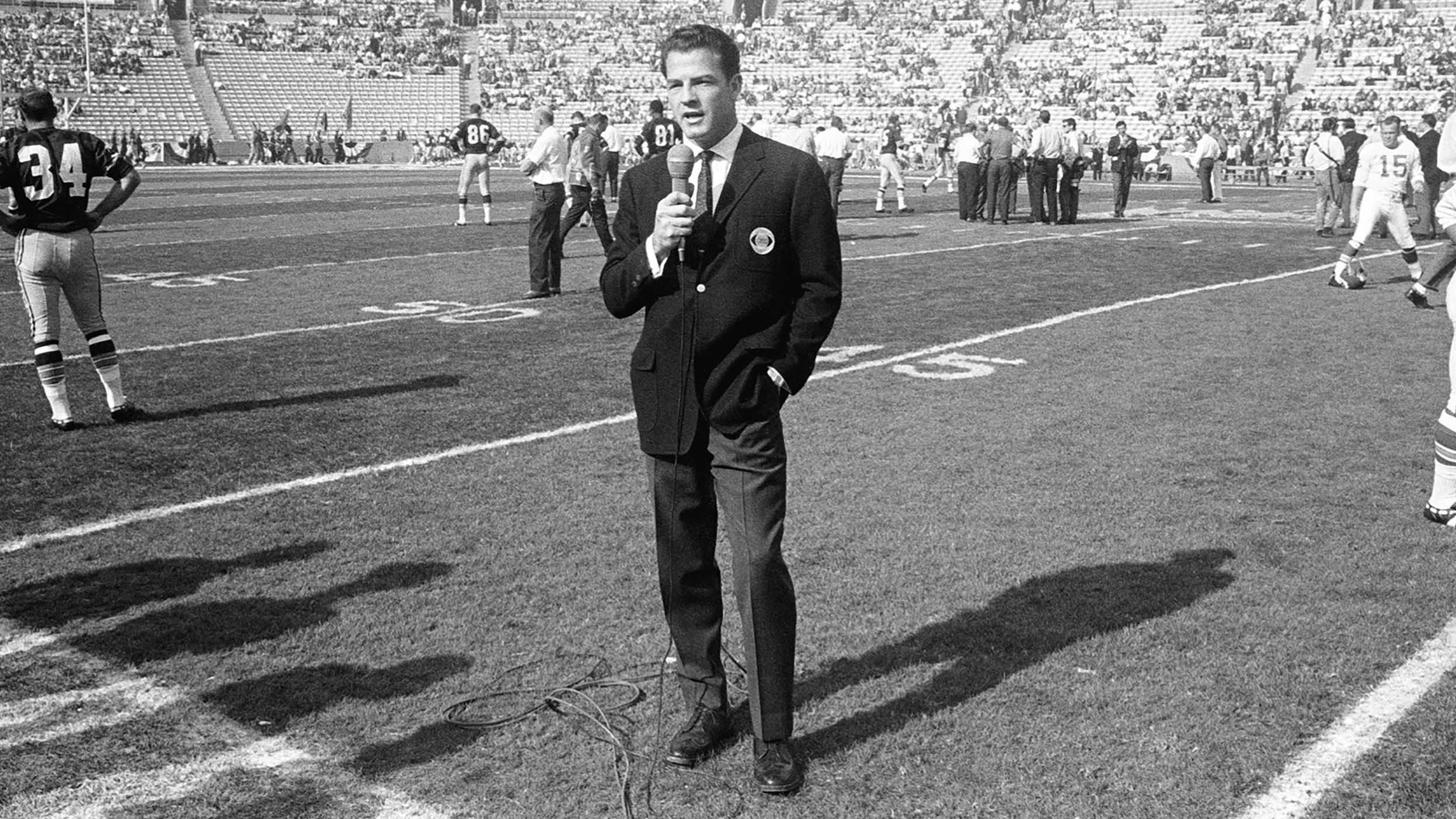 CBS commentator Frank Gifford works on the field before the game. The game was televised by both CBS and NBC. CBS held the rights to NFL games, while NBC had the rights to AFL games.
