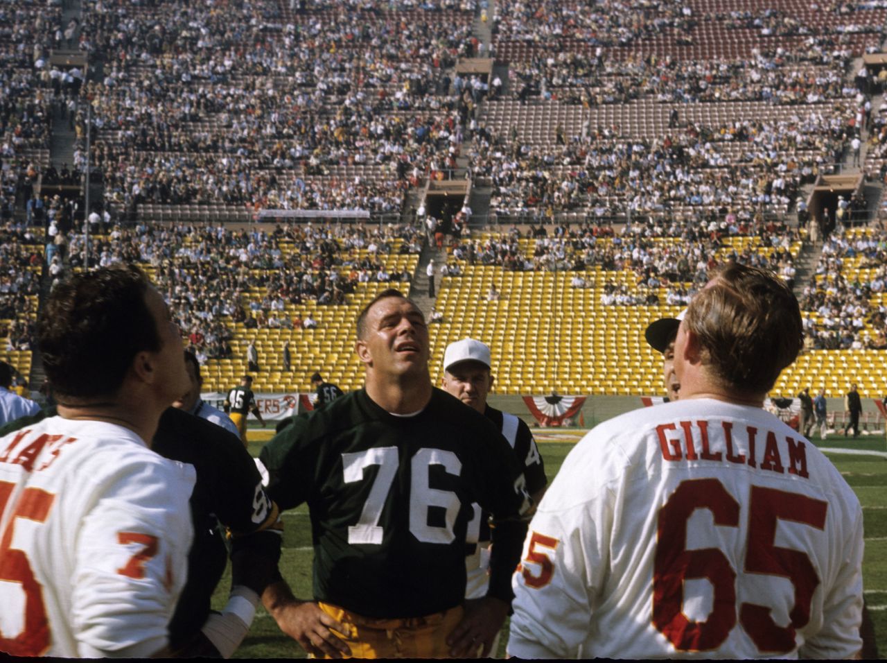 Chiefs center Jon Gilliam — across from Packers tackle Bob Skoronski — watches the pregame coin toss.