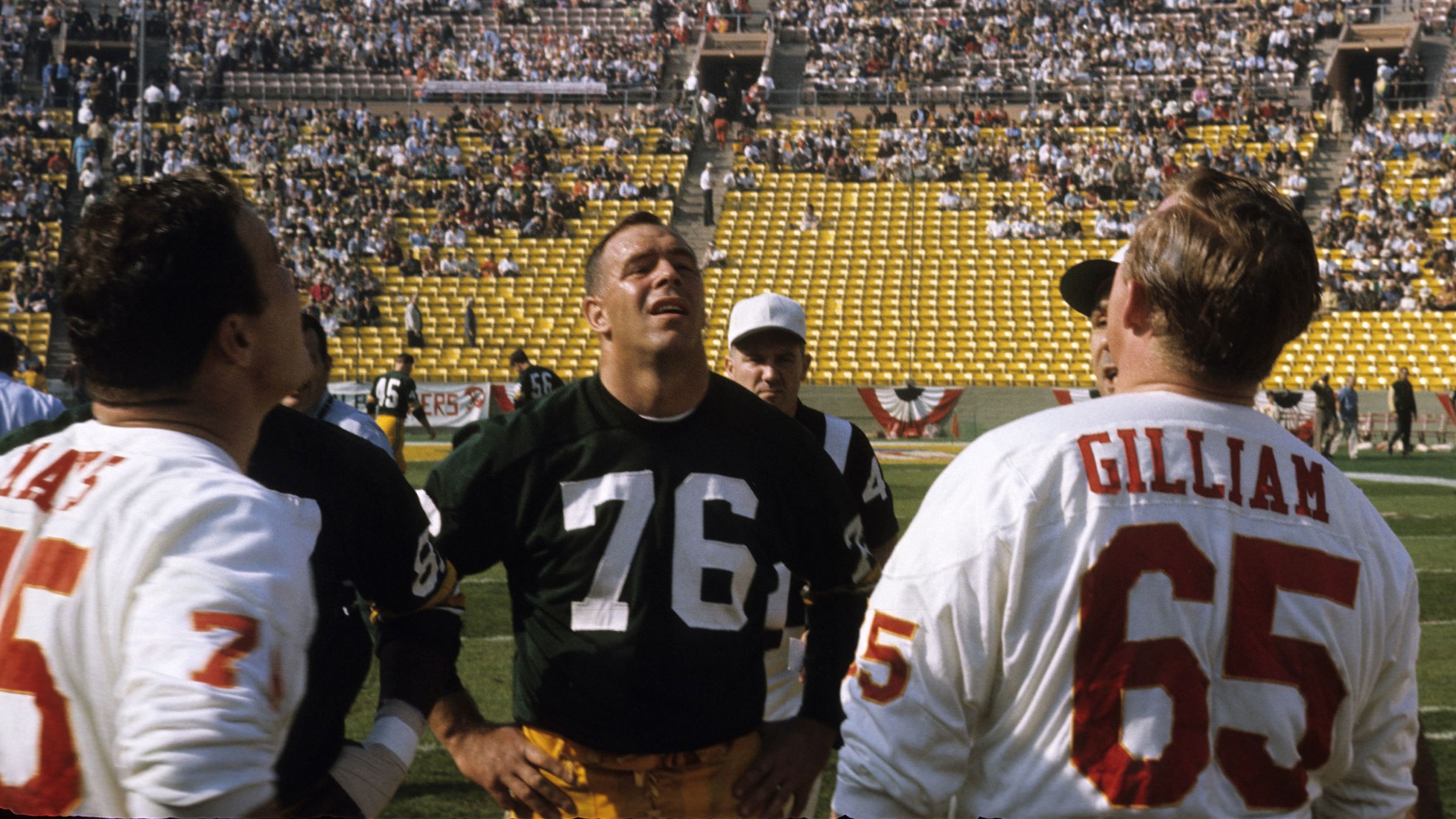 Chiefs center Jon Gilliam — across from Packers tackle Bob Skoronski — watches the pregame coin toss.