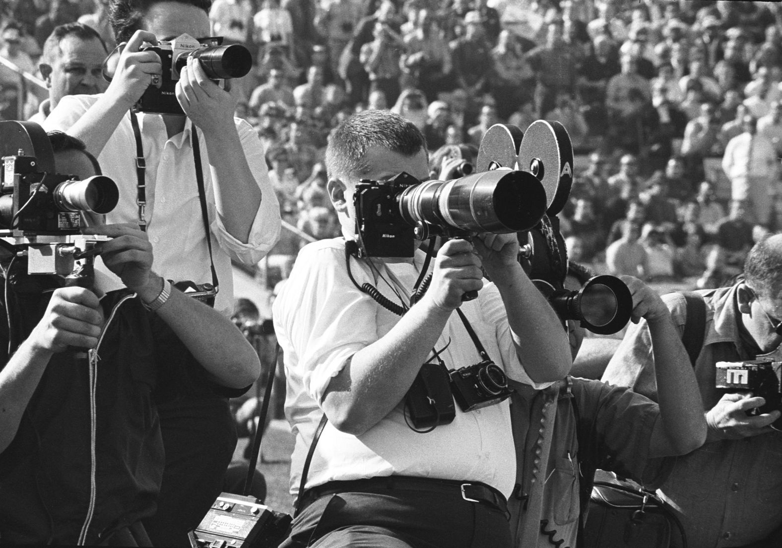 Photographers and cameramen work from the sideline.