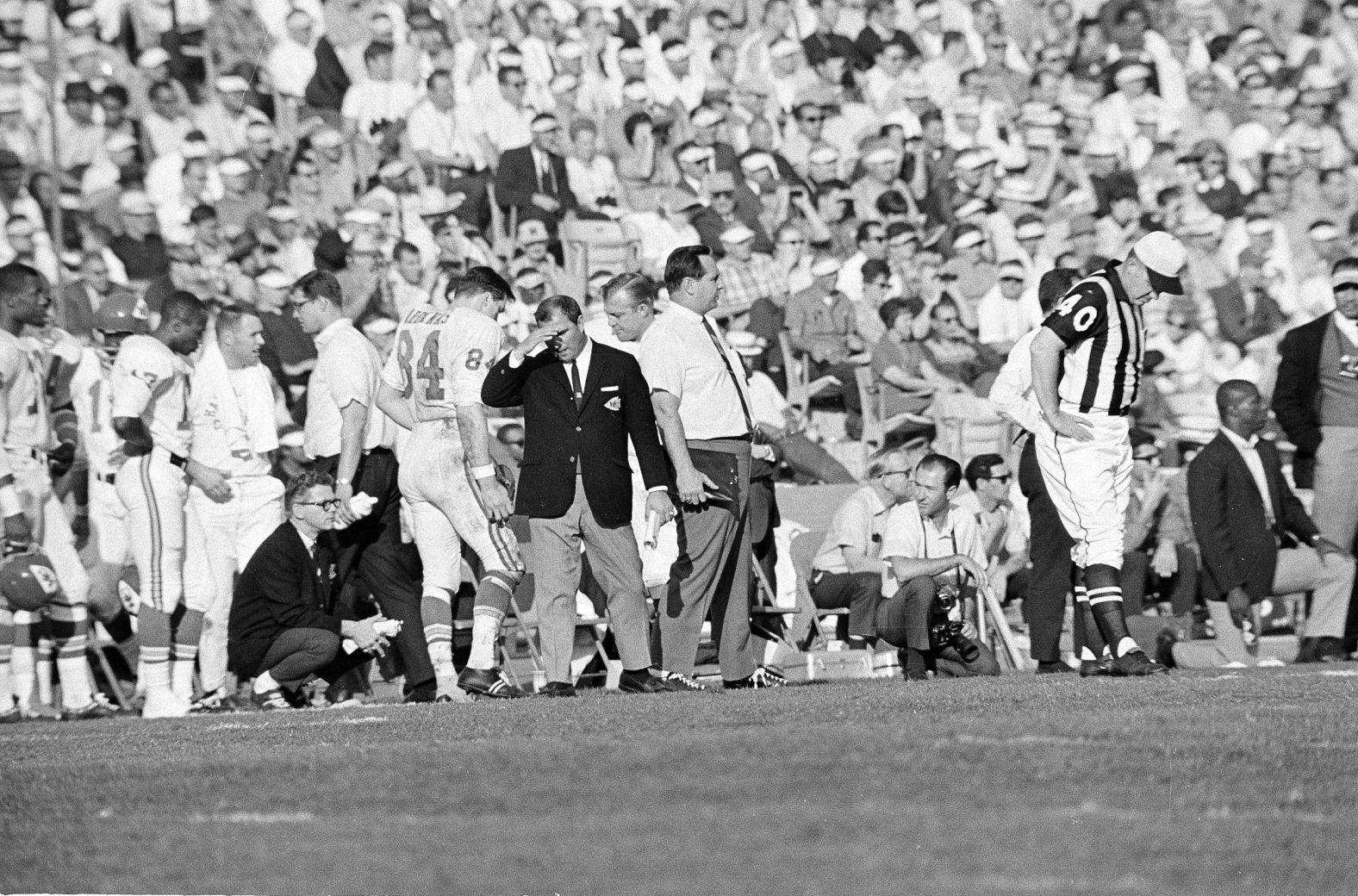 Chiefs head coach Hank Stram covers his face on the sideline. While this game did not go in his favor, he would be back three years later to win Super Bowl IV.