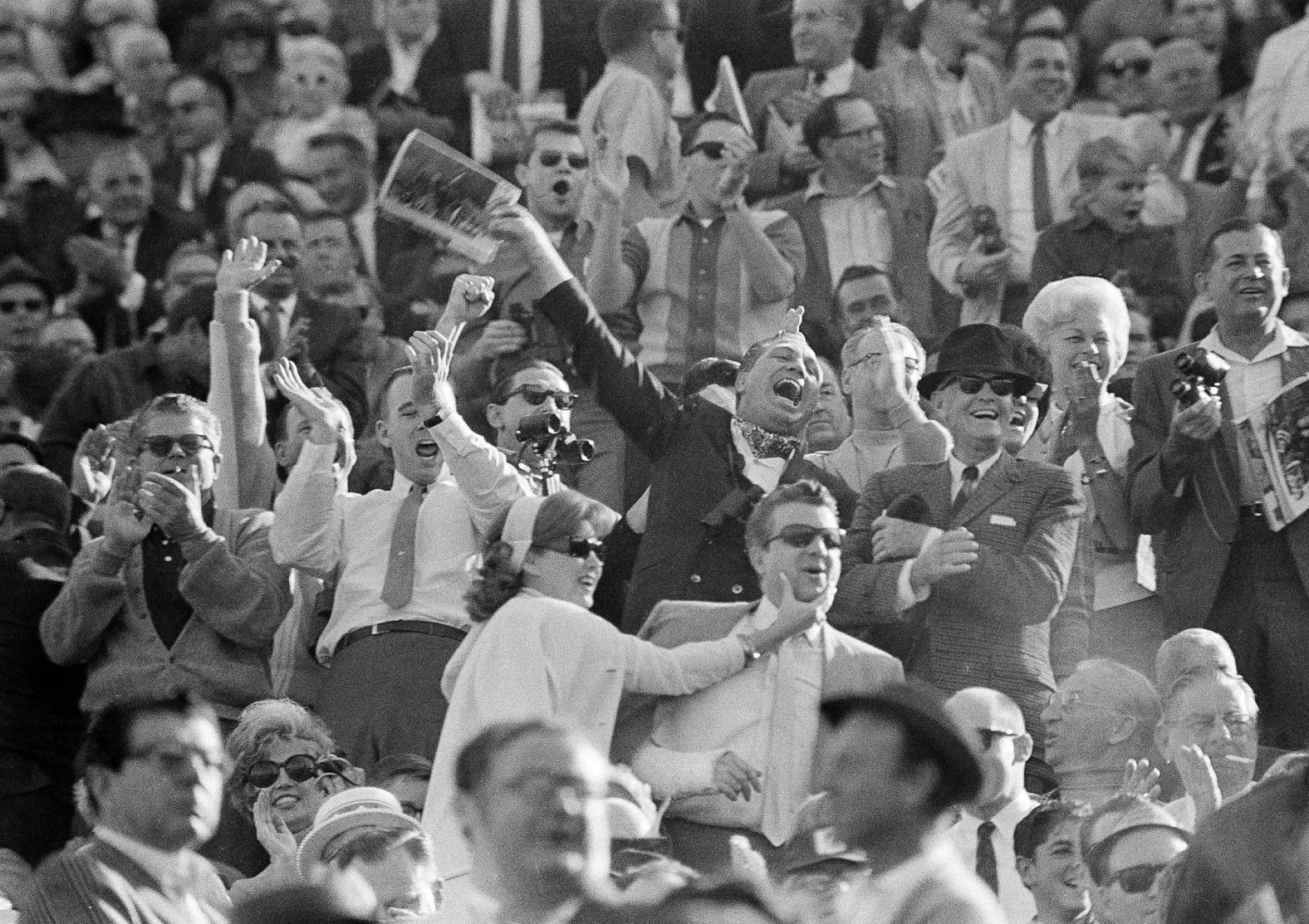 Packers fans cheer their team from the stands.