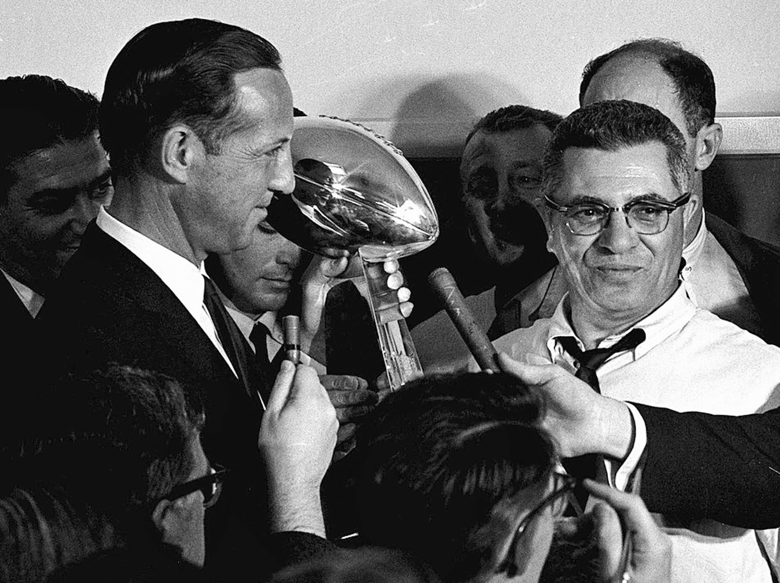 NFL commissioner Pete Rozelle, left, presents the championship trophy to Packers head coach Vince Lombardi after the game. The trophy was renamed the Vince Lombardi Trophy after the coach's death in 1970.