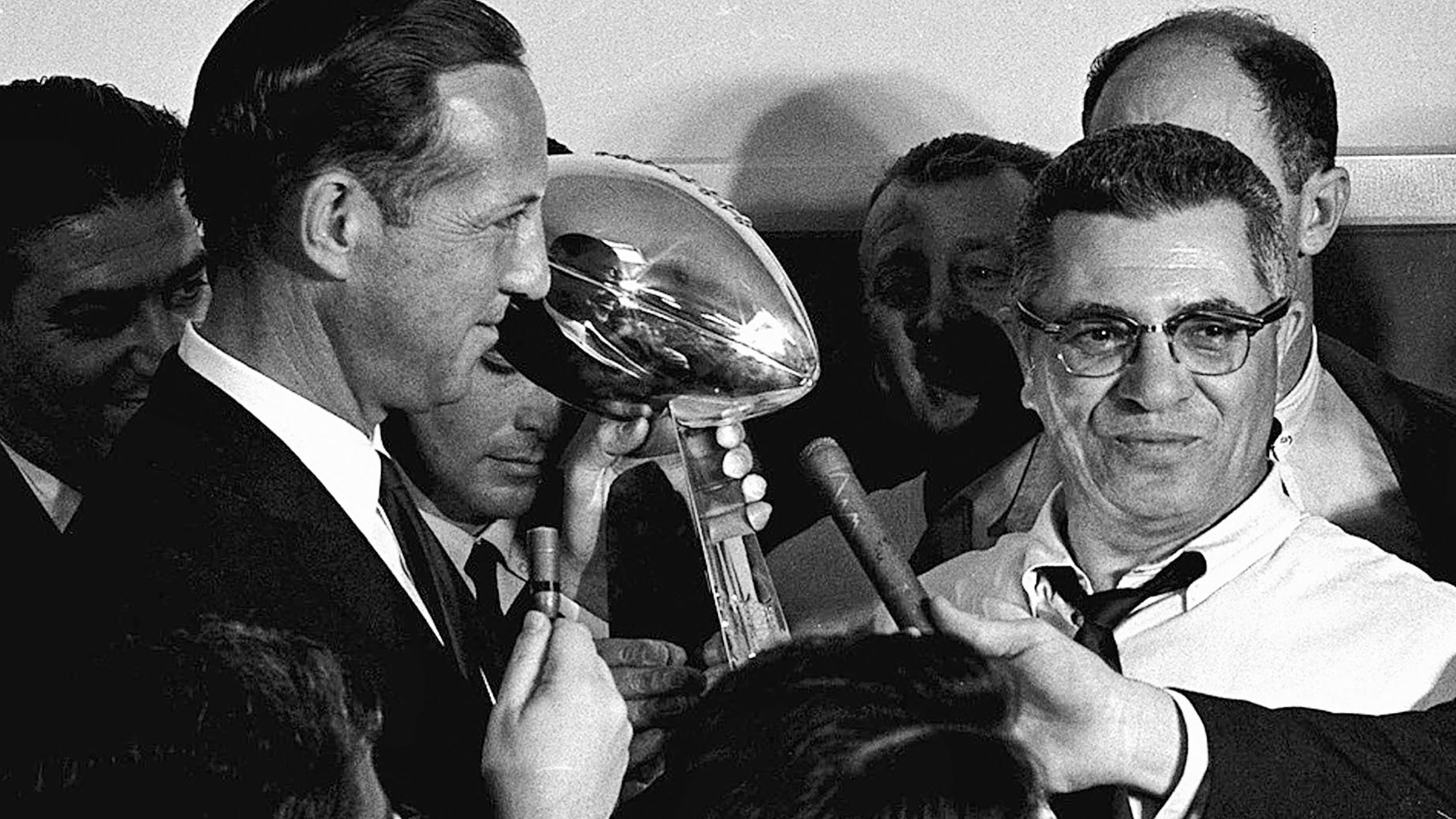 NFL commissioner Pete Rozelle, left, presents the championship trophy to Packers head coach Vince Lombardi after the game. The trophy was renamed the Vince Lombardi Trophy after the coach's death in 1970.