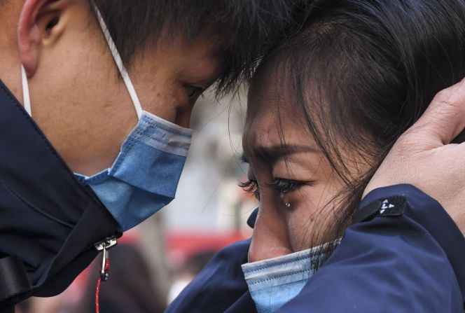 Lyu Jun, left, a member of a medical team leaving for Wuhan, says goodbye to a loved one in Urumqi, China, on January 28, 2020.