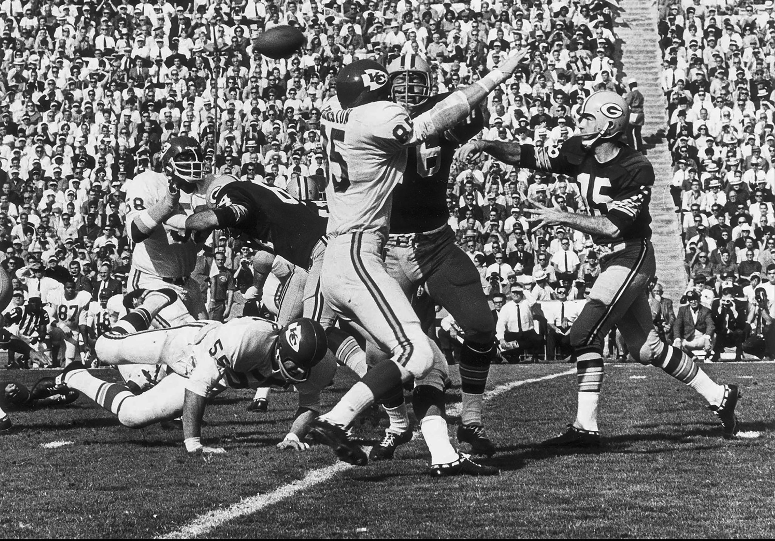 Green Bay Packers quarterback Bart Starr, right, passes the ball during the first-ever Super Bowl. Starr threw for 250 yards and two touchdowns as the Packers defeated the Kansas City Chiefs 35-10. Starr was named the game's Most Valuable Player.