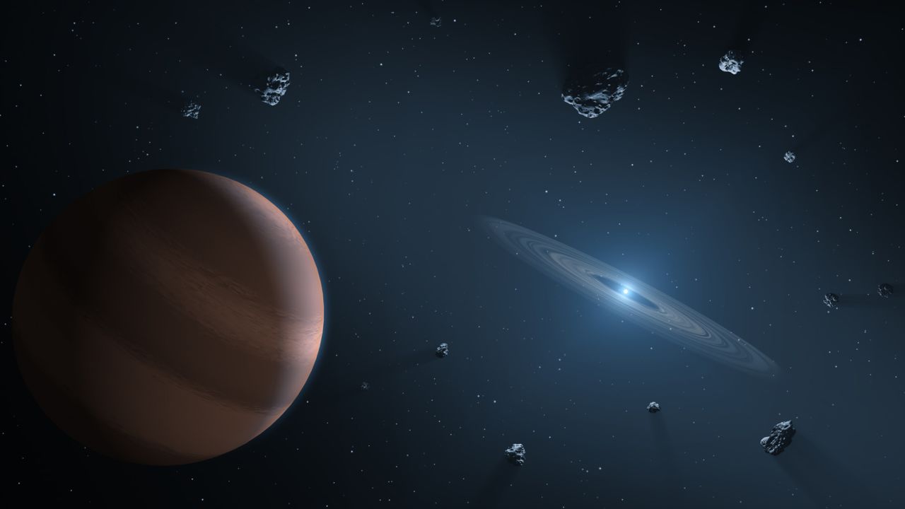 This illustration shows an exoplanet and debris orbiting a dead star, known as a white dwarf. 