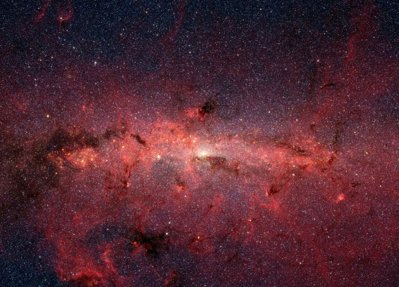 Spitzer captured hundreds of thousands of stars as they swirl at the center of the Milky Way galaxy. 