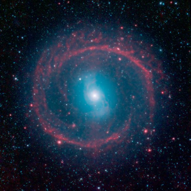 Spitzer peered into galaxy NGC 1291 and spied activity. The outer red ring is the result of new stars heating up dust, causing it to glow in the infrared. 