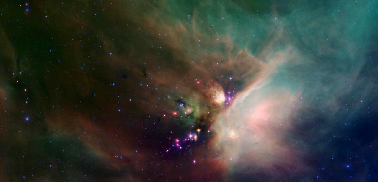 Spitzer was able to image newborn stars, like these cloaked in dust from the Rho Ophiuchi dark cloud.