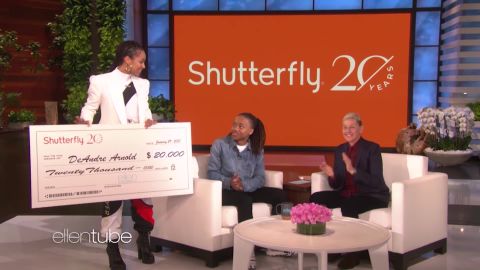 Singer Alicia Keys presents a check to DeAndre Arnold as Ellen DeGeneres applauds.