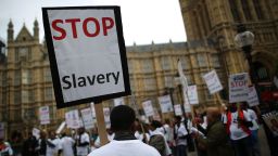  Anti-slavery activists rally outside Parliament on October 18, 2013, in London, England. 
