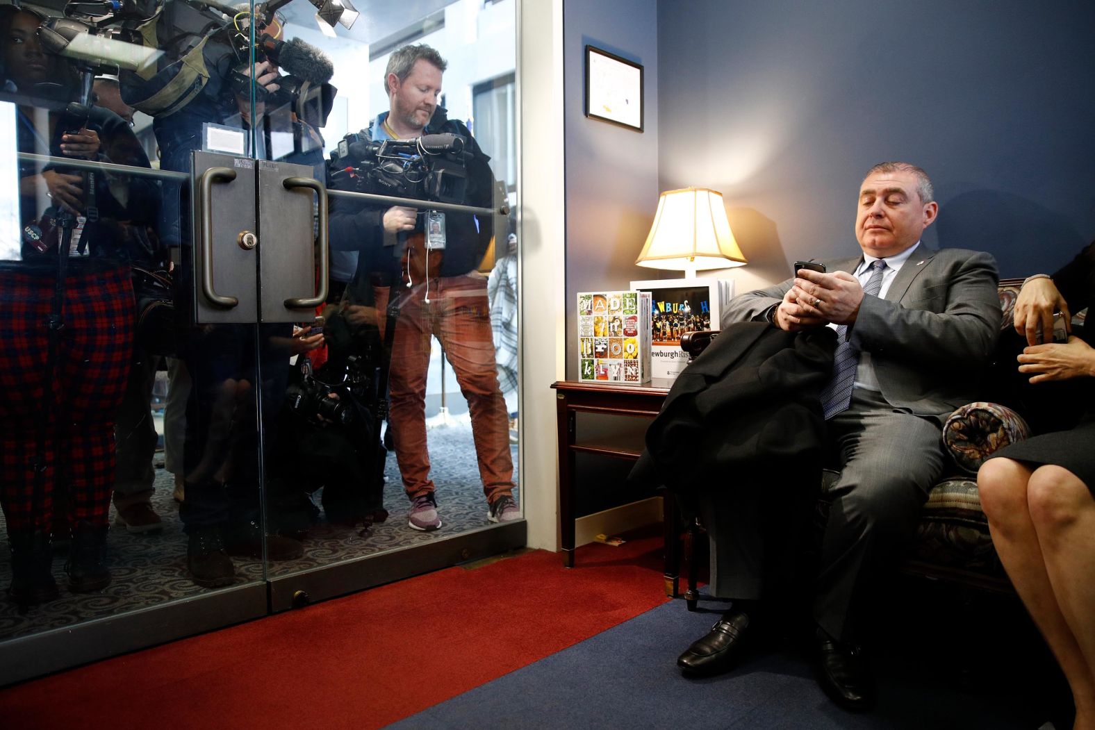 Lev Parnas, an indicted associate of Rudy Giuliani with ties to Ukraine, looks at his phone as he waits in the office of Senate Minority Leader Chuck Schumer on January 29. Parnas' work in Ukraine with Giuliani, the President's personal attorney, <a href="index.php?page=&url=https%3A%2F%2Fwww.cnn.com%2F2020%2F01%2F16%2Fpolitics%2Flev-parnas-cnn-interview%2Findex.html" target="_blank">stood at the center of the impeachment inquiry.</a>