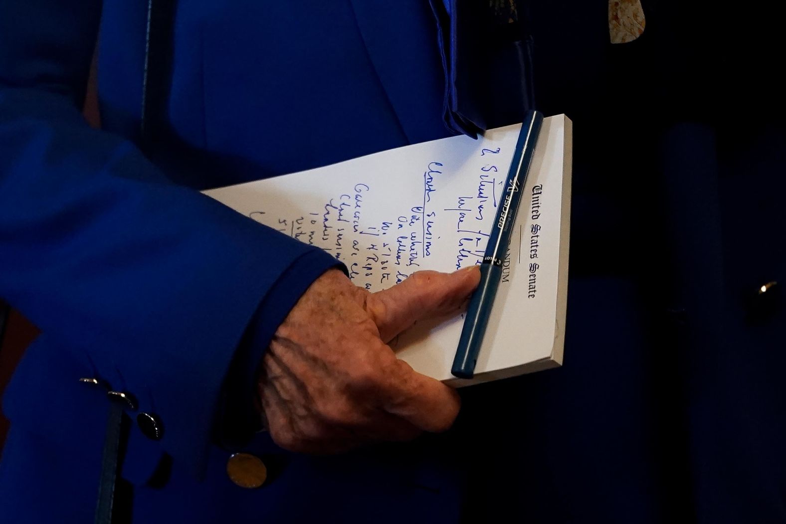 US Sen. Dianne Feinstein carries a notepad with her as she arrives at the Senate chamber on January 28.