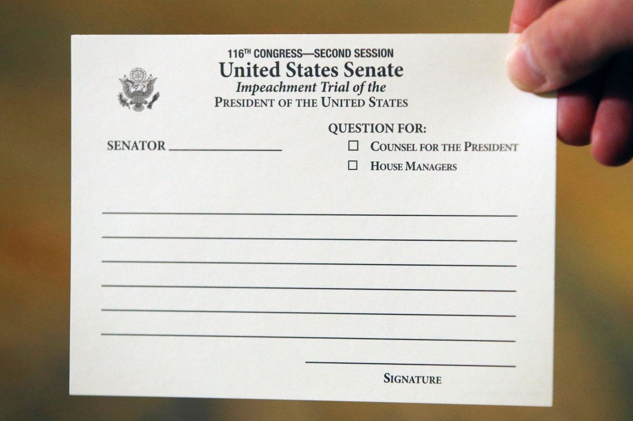 A Senate aide displays the question card that was being used by senators during the trial.