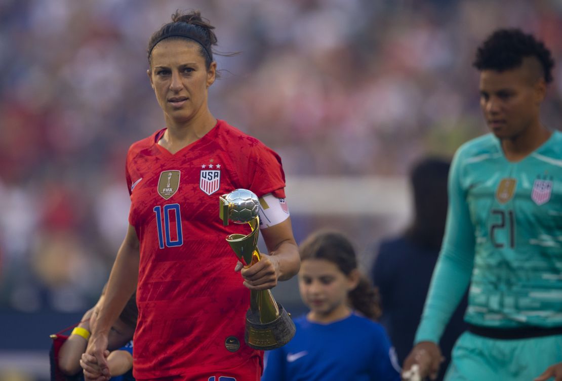 Carli Lloyd holds the World Cup during the US victory tour against Portugal.