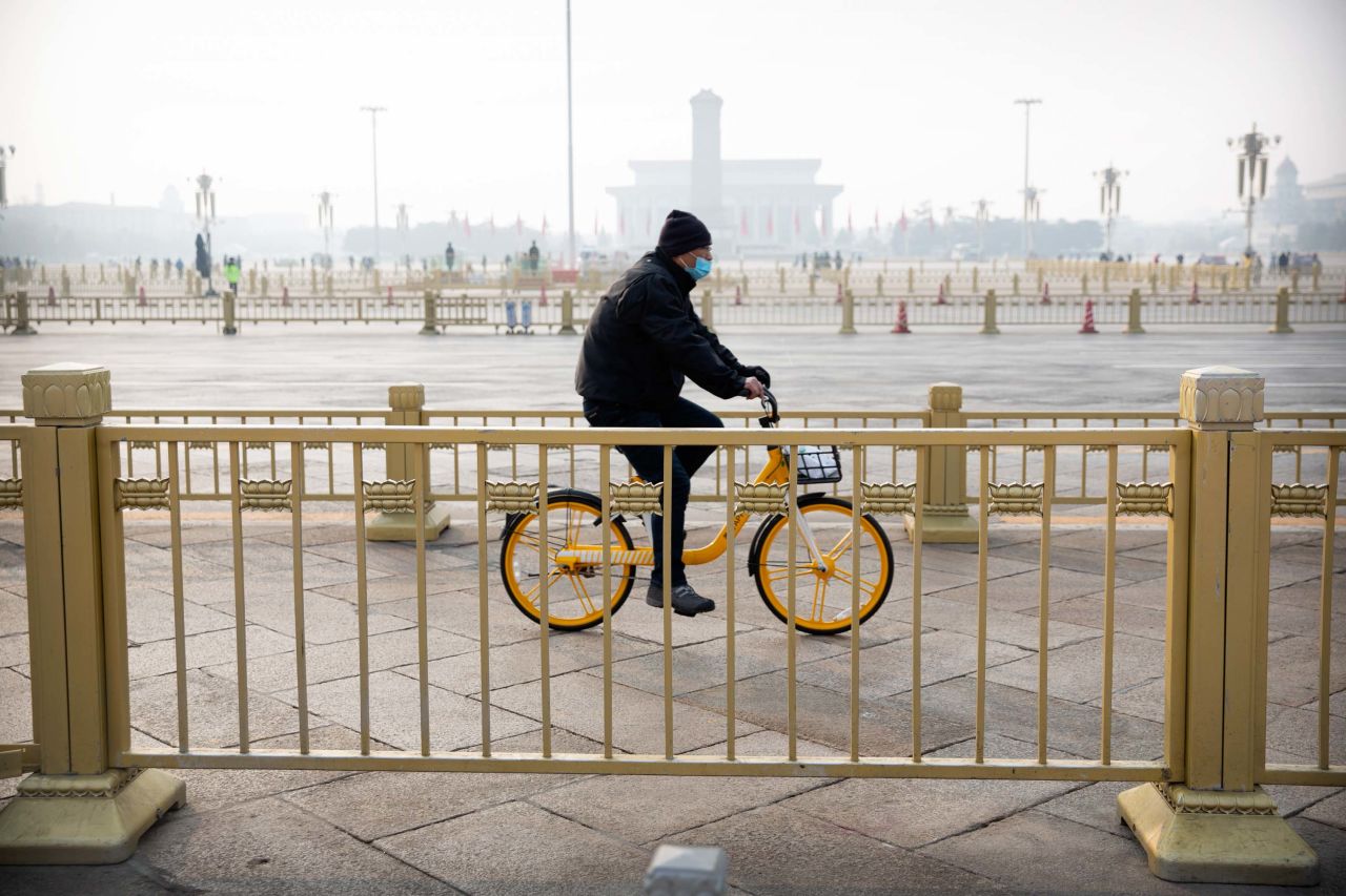 A cyclist rides past Beijing's Tiananmen Square, normally crowded with tourists during the Lunar New Year holiday, on January 27.