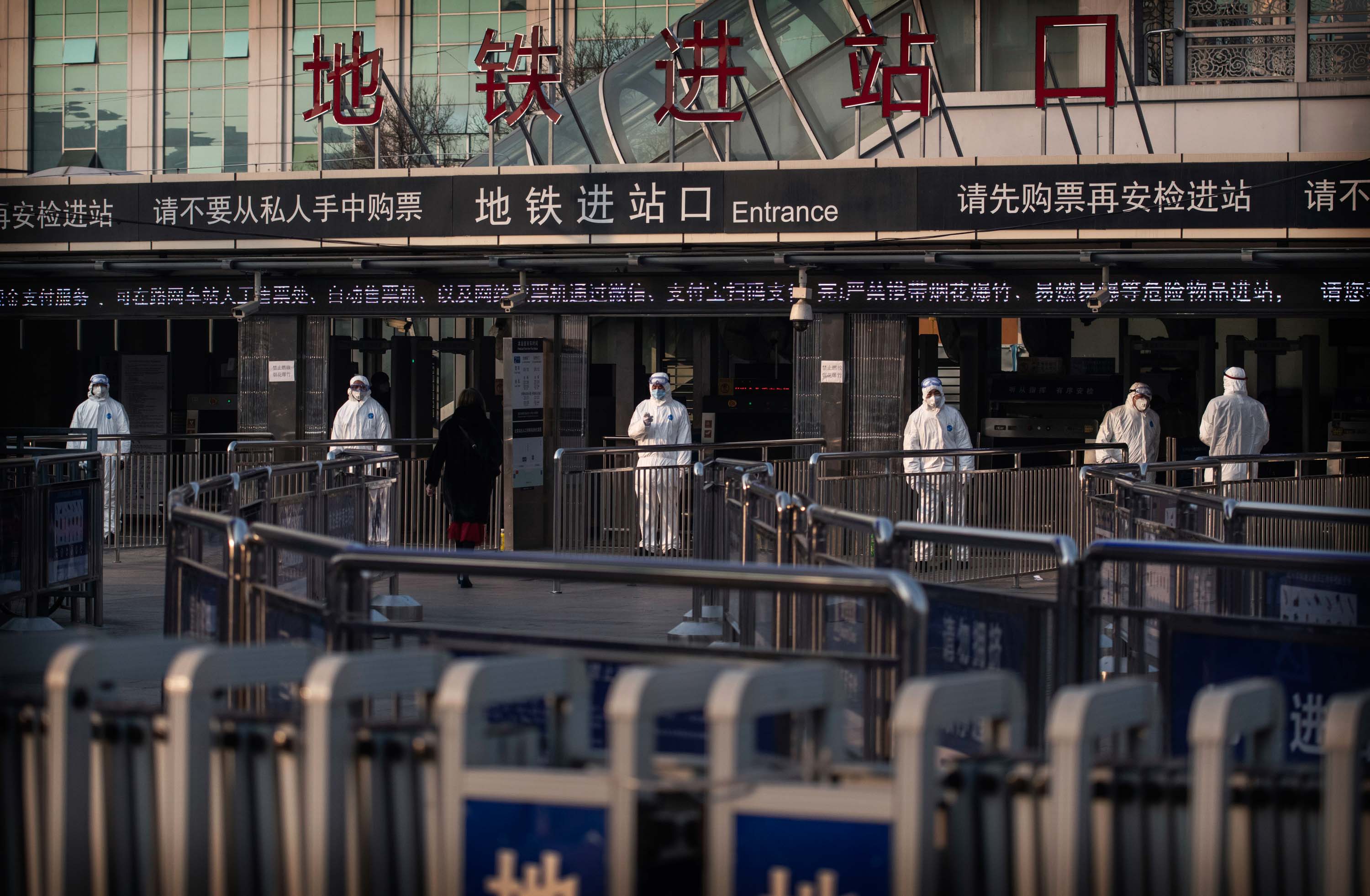 Chinese health workers standby to check the temperature of travelers entering a subway station in Beijing, China, on January 25.