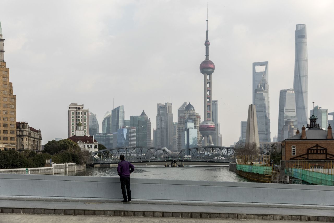 A pedestrian walks near the Bund, usually a busy commercial and tourism area in Shanghai on January 29.