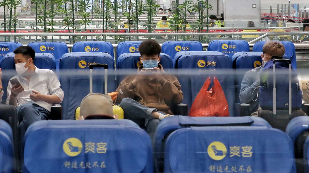 A cluster of passengers wait at Luohu railway station in Shenzhen on January 22.