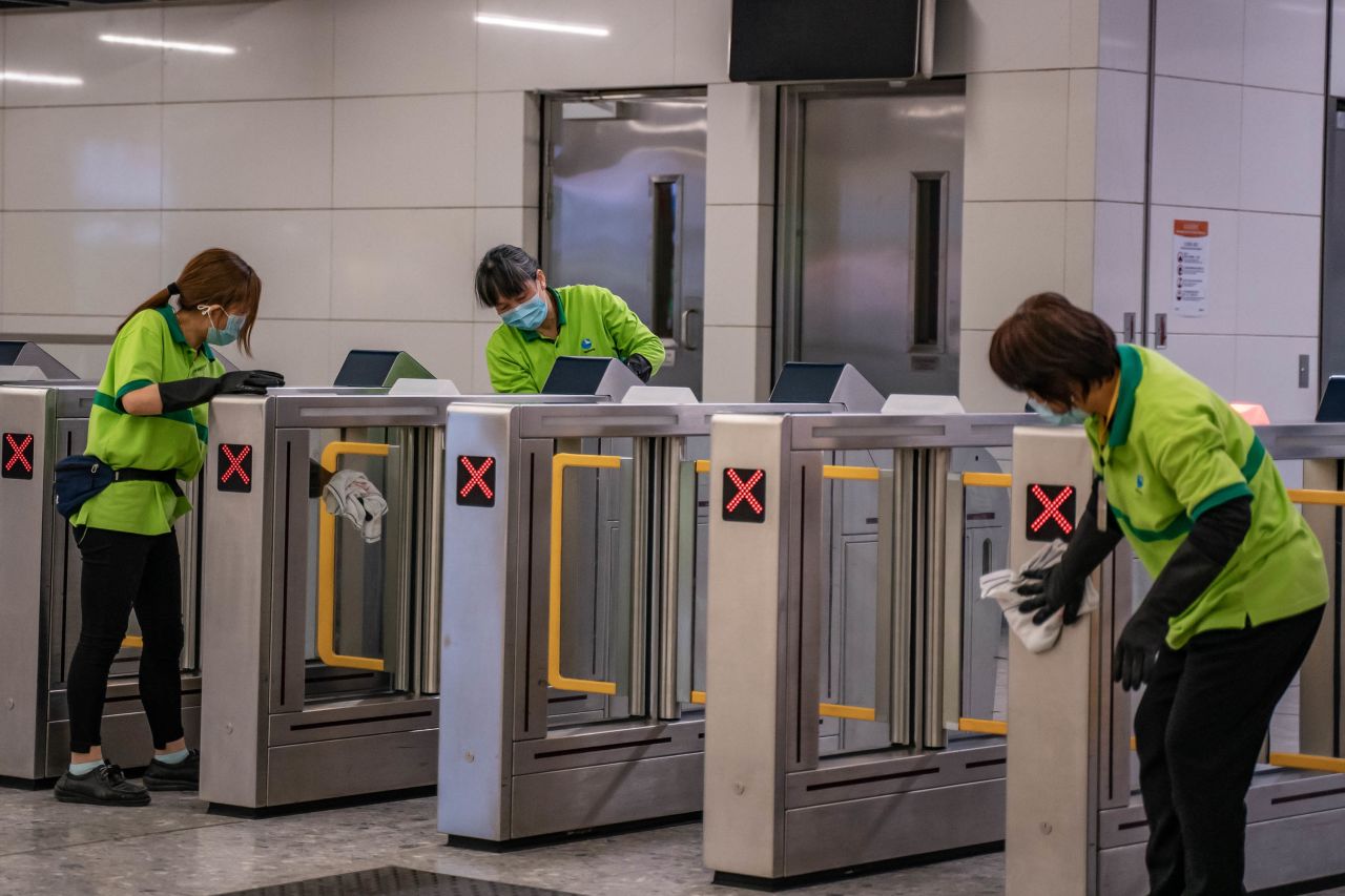 Workers clean a gate at Hong Kong's High Speed Rail Station on January 29. The city's government announced it will deny entry for travelers who has been to China's Hubei province, the epicenter of the outbreak, except for local residents. Hong Kong has also closed many of its border crossings with mainland China, amid calls from residents for more stringent measures.