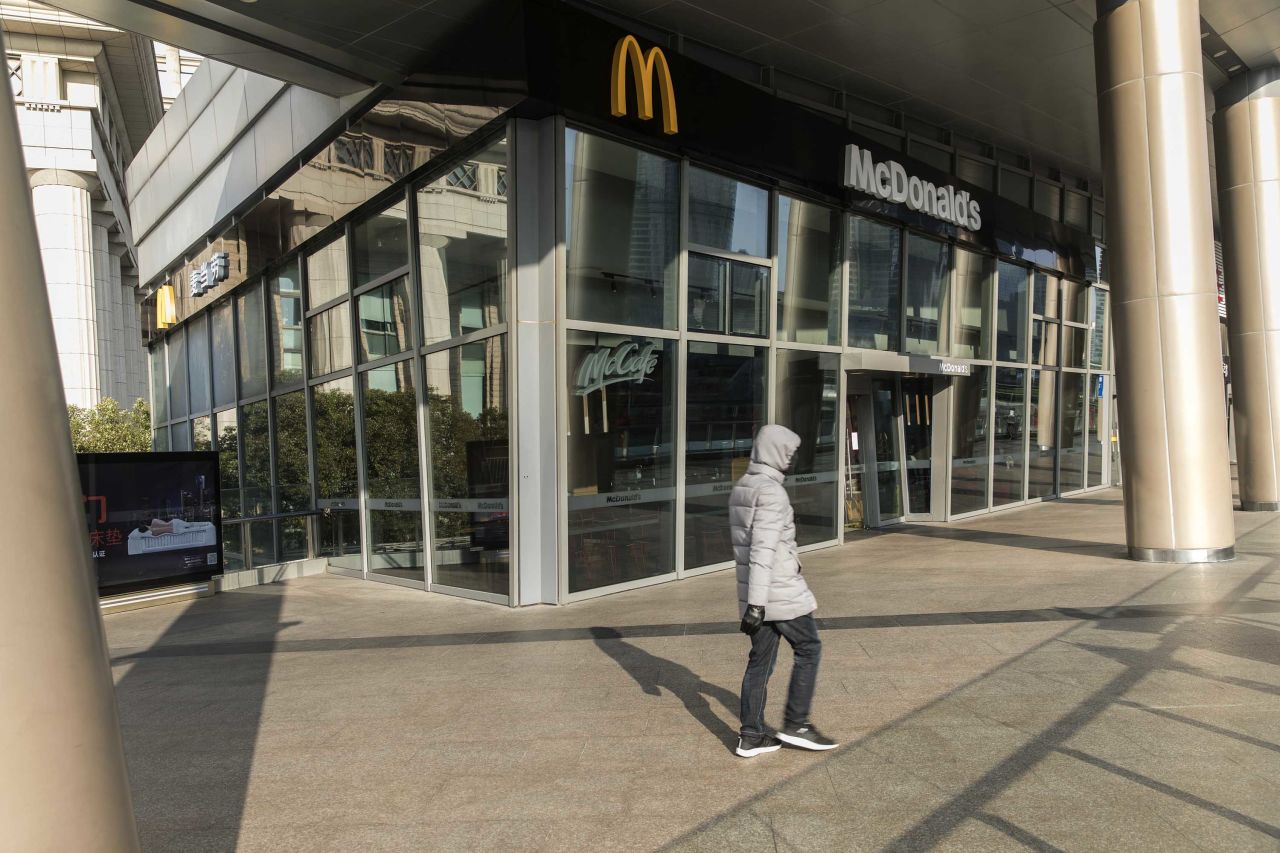 A pedestrian passes a closed McDonald's restaurant in Shanghai on January 30.