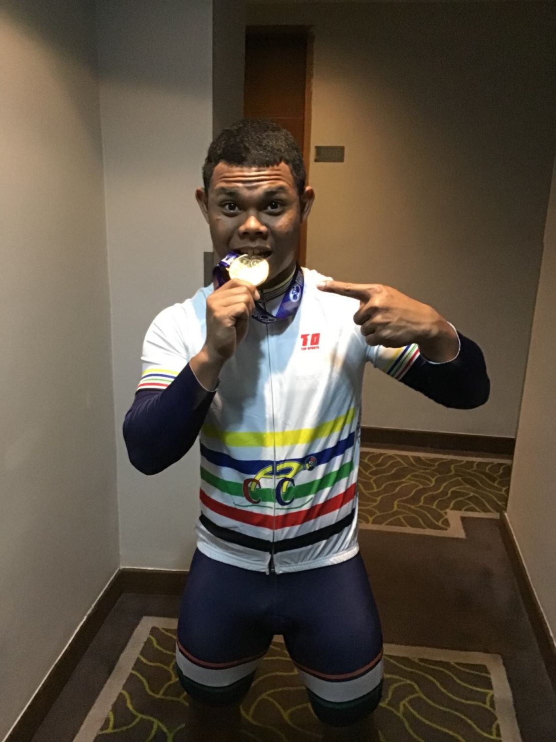 Tasting success: Esow shows off his gold medal from the world junior track championships.