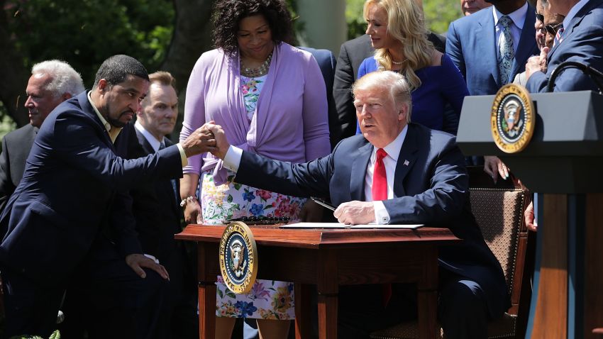 WASHINGTON, DC - MAY 03:  U.S. President Donald Trump shakes hands with Pastor Darrell Scott, co-founder of the New Sirit Revival Center, before Trump signs an executive order during an event in the Rose Garden to mark the National Day of Prayer at the White House May 3, 2018 in Washington, DC. The White House invited leaders from varios faiths and religions to participate in the day of prayer, which was designated in 1952 by the United States Congress to ask people "to turn to God in prayer and meditation."  (Photo by Chip Somodevilla/Getty Images)