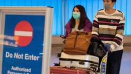 Passengers wear protective masks to protect against the spread of the Coronavirus as they arrive at the Los Angeles International Airport, California, on January 22, 2020. - A new virus that has killed nine people, infected hundreds and has already reached the US could mutate and spread, China warned on January 22, as authorities urged people to steer clear of Wuhan, the city at the heart of the outbreak.(Mark Ralston/Getty Images)