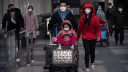 BEIJING, CHINA - JANUARY 30: Passengers wear protective masks as they walk he their luggagein the arrivals area at Beijing Capital Airport on January 30, 2020 in Beijing, China. The number of cases of a deadly new coronavirus rose to over 7000 in mainland China Thursday as the country continued to lock down the city of Wuhan in an effort to contain the spread of the pneumonia-like disease which medicals experts have confirmed can be passed from human to human. In an unprecedented move, Chinese authorities put travel restrictions on the city which is the epicentre of the virus and neighbouring municipalities affecting tens of millions of people. The number of those who have died from the virus in China climbed to over 170 on Thursday, mostly in Hubei province, and cases have been reported in other countries including the United States, Canada, Australia, Japan, South Korea, and France. The World Health Organization  has warned all governments to be on alert, and its emergency committee is to meet later on Thursday to decide whether to declare a global health emergency. (Photo by Kevin Frayer/Getty Images)
