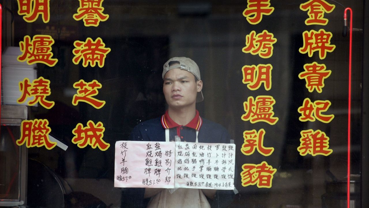 An employee of an empty Chinatown restaurant in Chicago on April 24, 2003, as fears over the SARS epidemic kept customers away.