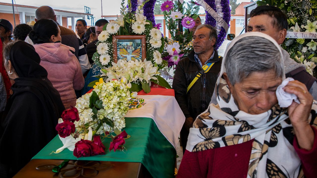 People mourn next to the coffin with the remains of Mexican environmentalist Homero Gomez, during his funeral in El Rosario village.