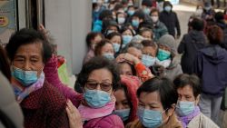 People queue up to buy face masks at a cosmetics shop in Hong Kong, Thursday, Jan. 30, 2020. Hong Kong cut off rail service to mainland China at midnight on Wednesday to Thursday to try to stop the spread of a new virus to the city. The death toll rose to 170 in the new virus outbreak in China on Thursday as foreign evacuees from the worst-hit region begin returning home under close observation and world health officials expressed "great concern" that the disease is starting to spread between people outside of China. (AP Photo/Kin Cheung)