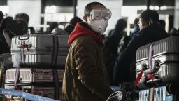 BEIJING, CHINA - JANUARY 30: A man wears a protective mask and goggles as he lines up to check in to a flight at Beijing Capital Airport on January 30, 2020 in Beijing, China. The number of cases of a deadly new coronavirus rose to over 7000 in mainland China Thursday as the country continued to lock down the city of Wuhan in an effort to contain the spread of the pneumonia-like disease which medicals experts have confirmed can be passed from human to human. In an unprecedented move, Chinese authorities put travel restrictions on the city which is the epicentre of the virus and neighbouring municipalities affecting tens of millions of people. The number of those who have died from the virus in China climbed to over 170 on Thursday, mostly in Hubei province, and cases have been reported in other countries including the United States, Canada, Australia, Japan, South Korea, and France. The World Health Organization  has warned all governments to be on alert, and its emergency committee is to meet later on Thursday to decide whether to declare a global health emergency. (Photo by Kevin Frayer/Getty Images) 