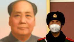 A paramilitary police officer wearing a protective facemasks to help stop the spread of a deadly SARS-like virus which originated in the central city of Wuhan, stand on guard in front of the portrait of late communist leader Mao Zedong at Tiananmen Gate in Beijing on January 28, 2020. - The deadly new coronavirus that has broken out in China, 2019-nCoV, will afflict a minimum of tens of thousands of people and will last at least several months, researchers estimate based on the first available data. (Photo by NOEL CELIS / AFP) (Photo by NOEL CELIS/AFP via Getty Images)
