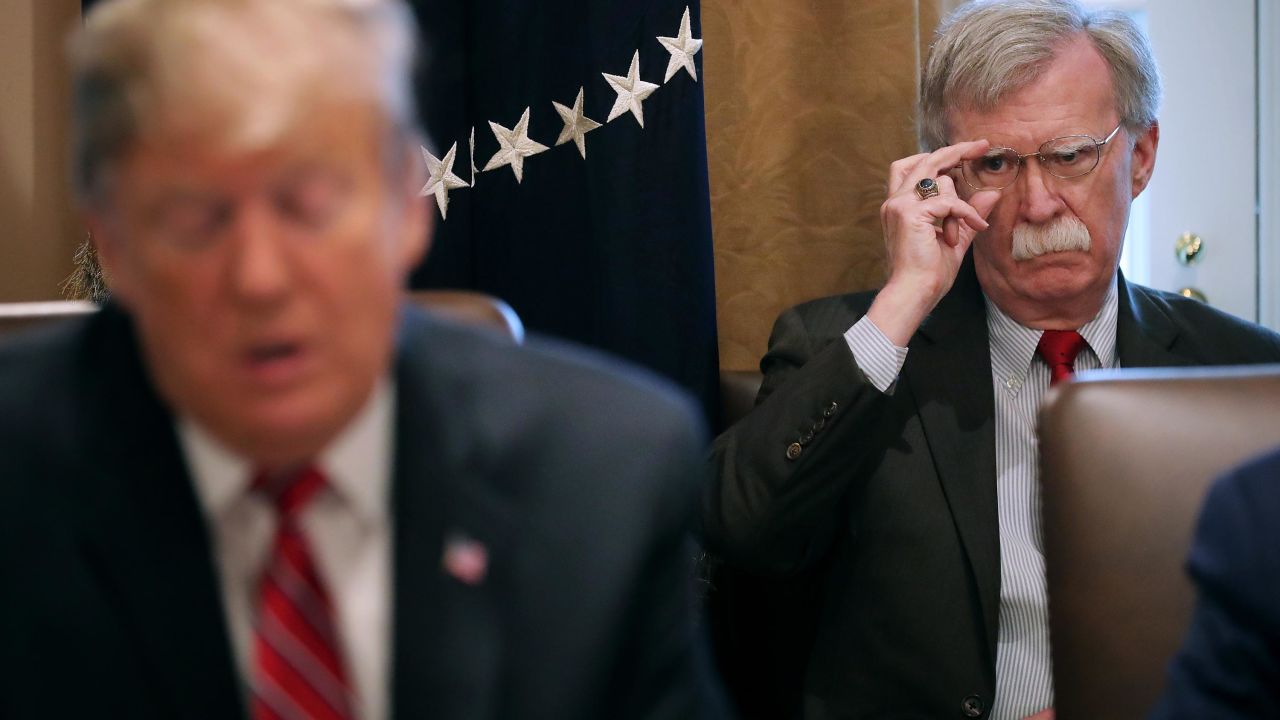 National Security Advisor John Bolton (R) listens to U.S. President Donald Trump talk to reporters during a meeting of his cabinet in the Cabinet Room at the White House February 12, 2019 in Washington, DC.