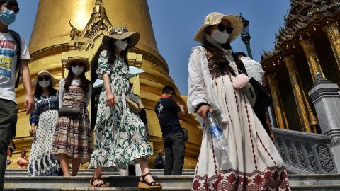 Tourists wearing face masks visit the Grand Palace in Bangkok on January 29, 2020. - Thailand has detected 14 cases so far of the novel coronavirus, a virus similar to the SARS pathogen, an outbreak which began in the Chinese city of Wuhan. (Photo by Lillian SUWANRUMPHA / AFP) (Photo by LILLIAN SUWANRUMPHA/AFP via Getty Images)
