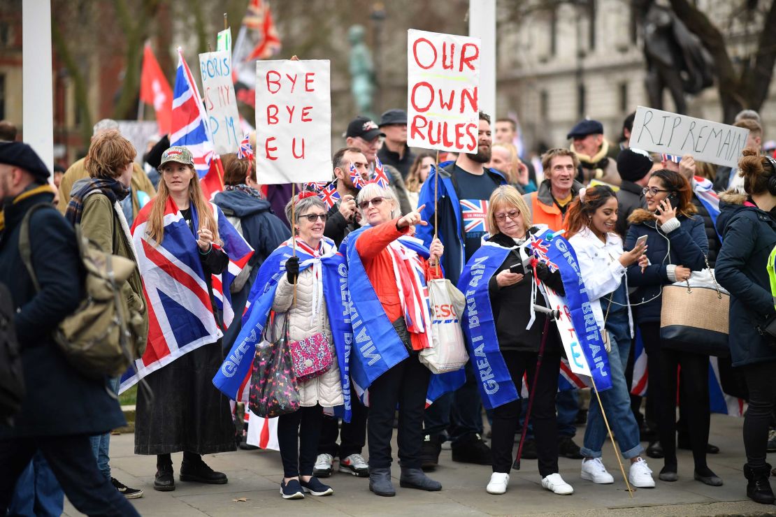 Brexit supporters waved placards at Parliament Square in London as the UK officially left the European Union on Friday.