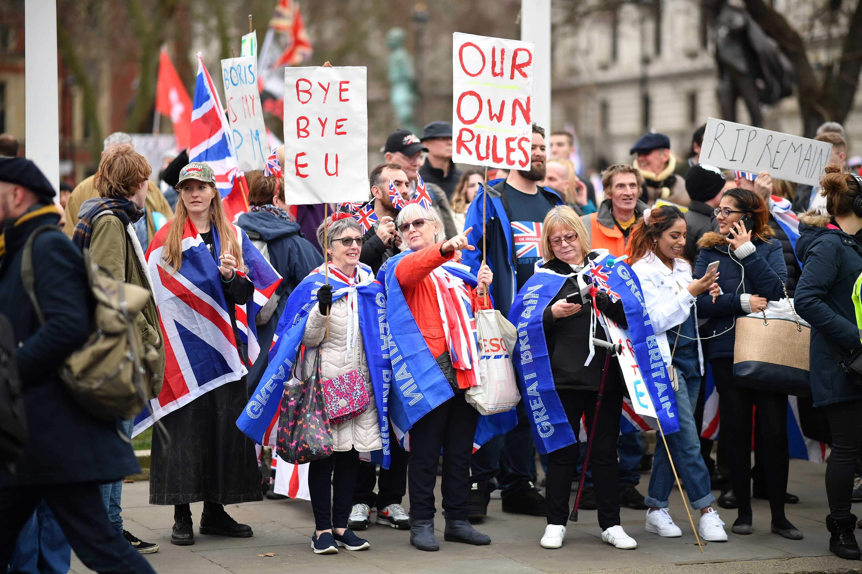 "Brexit" supporters wave placards at Parliament Square in London on Friday, January 31.