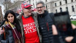 Brexit supporters have their picture taken in Parliament Square in London, Friday, Jan. 31, 2020. Britain officially leaves the European Union on Friday after a debilitating political period that has bitterly divided the nation since the 2016 Brexit referendum. (AP Photo/Alastair Grant)