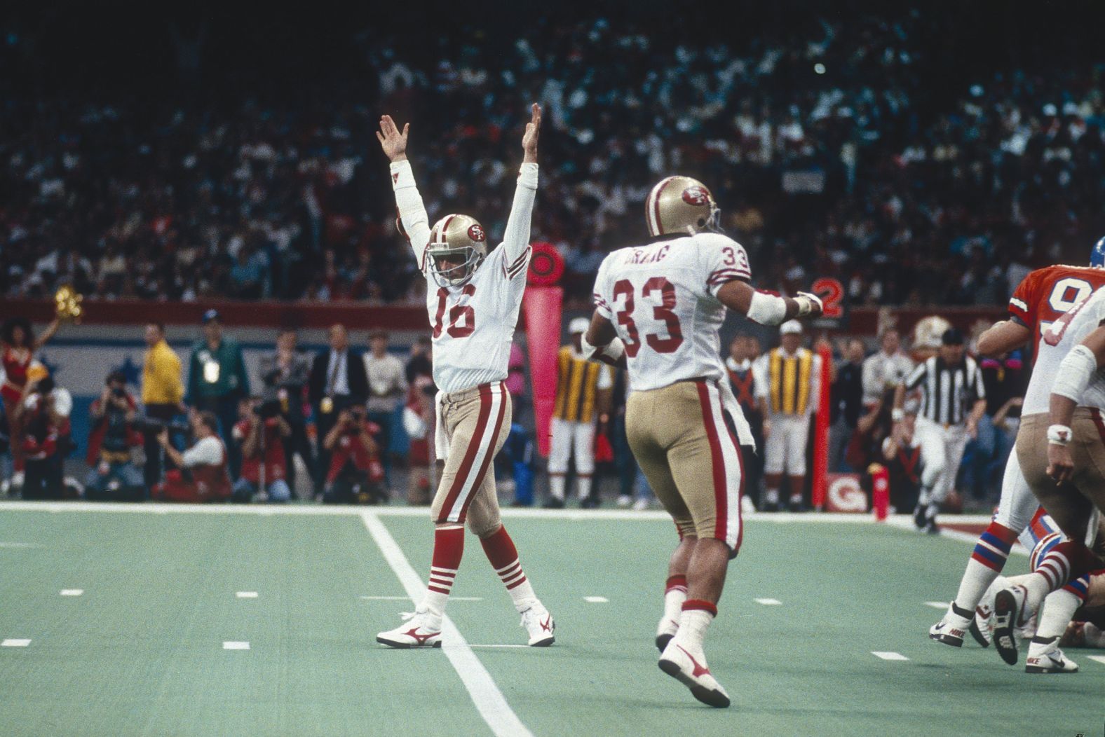 <strong>Super Bowl XXIV (1990):</strong> San Francisco quarterback Joe Montana raises his arms in celebration after a 49ers touchdown in Super Bowl XXIV. Montana had 297 yards passing and five touchdowns as the 49ers defeated Denver 55-10. It was the biggest blowout in Super Bowl history. Montana collected his third MVP award, and the 49ers capped a glorious run with four titles in nine years.