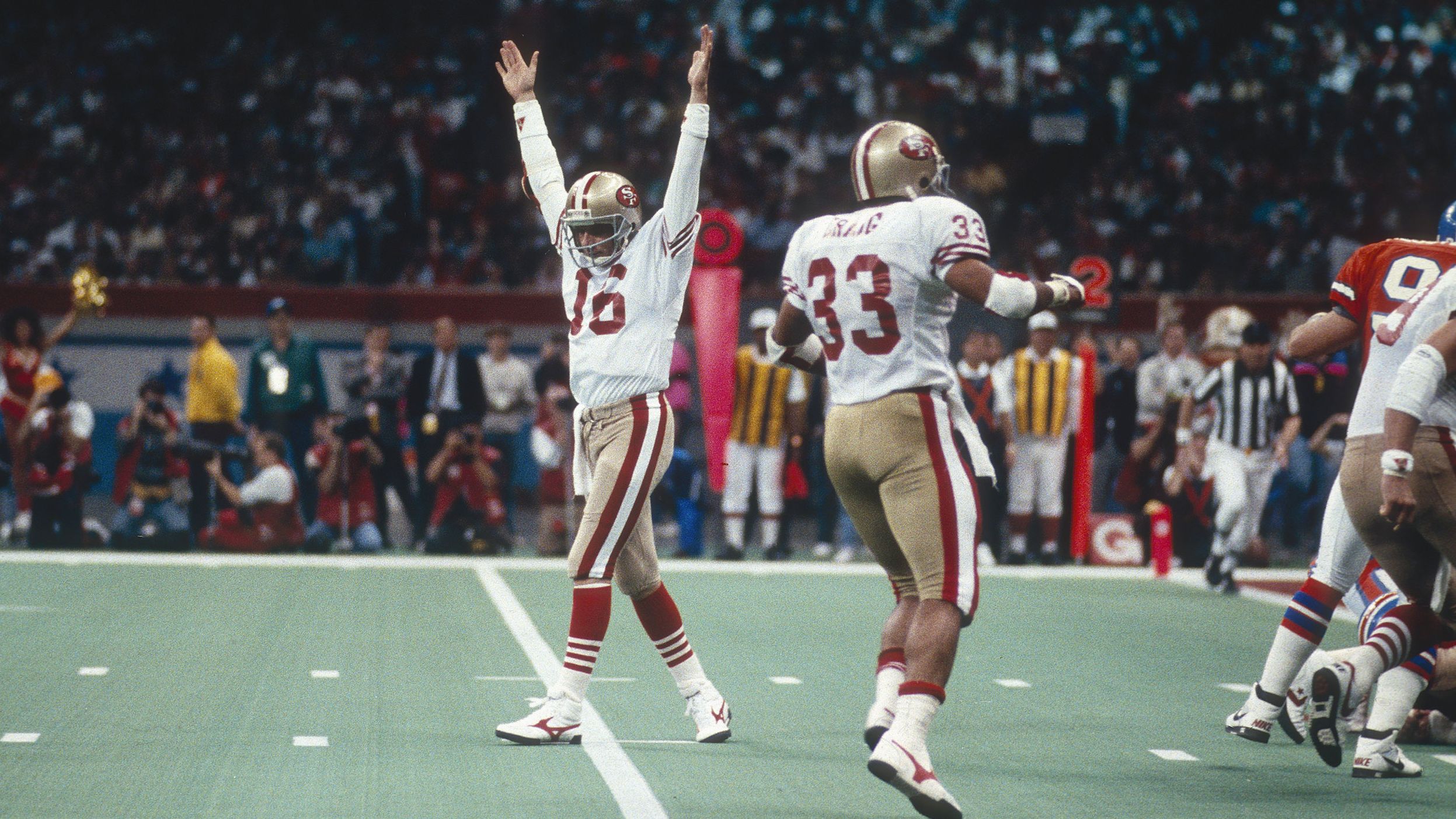 <strong>Super Bowl XXIV (1990):</strong> San Francisco quarterback Joe Montana raises his arms in celebration after a 49ers touchdown in Super Bowl XXIV. Montana had 297 yards passing and five touchdowns as the 49ers defeated Denver 55-10. It was the biggest blowout in Super Bowl history. Montana collected his third MVP award, and the 49ers capped a glorious run with four titles in nine years.