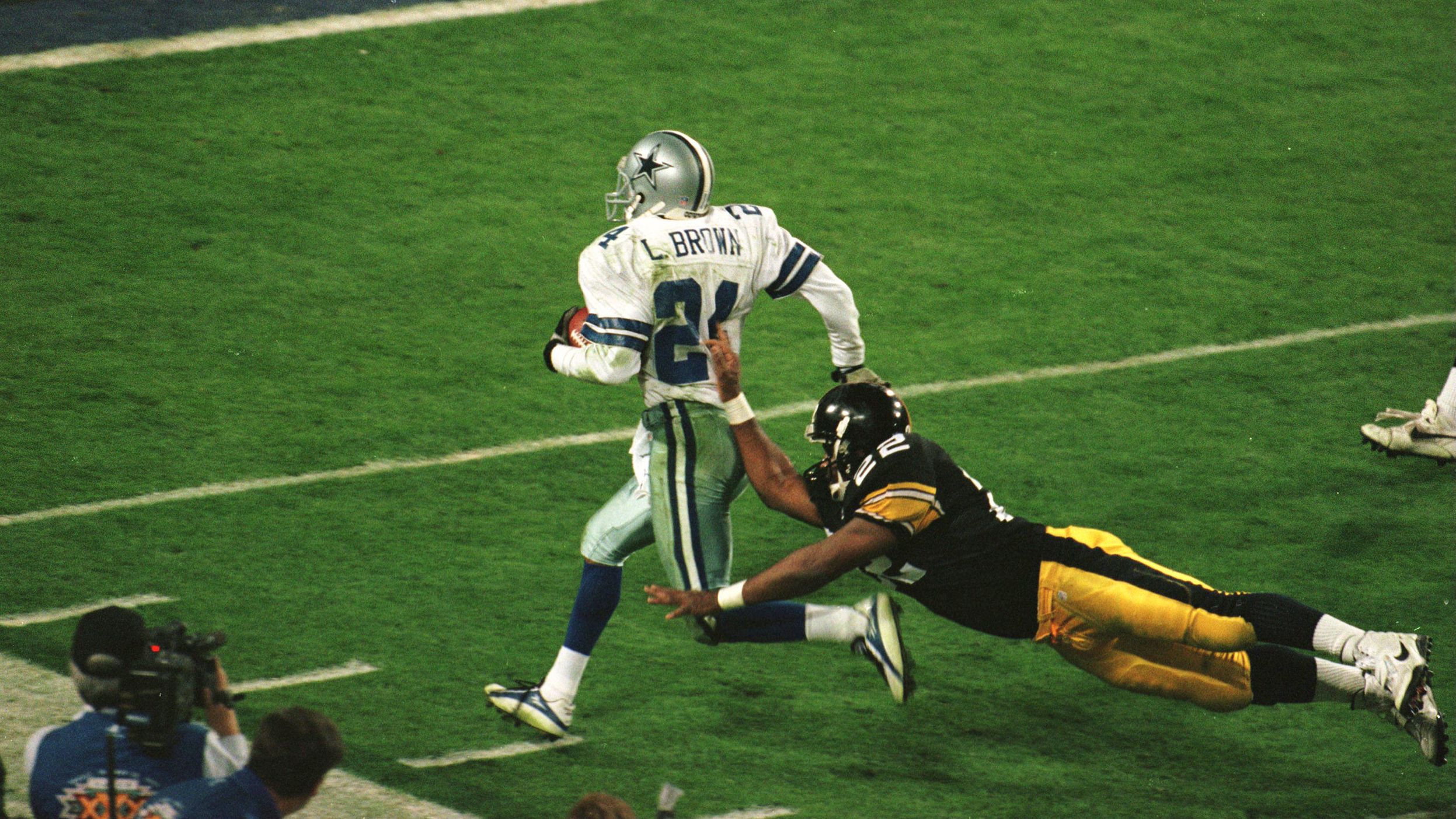 <strong>Super Bowl XXX (1996):</strong> Dallas Cowboys cornerback Larry Brown is pushed out of bounds after one of his two interceptions in Super Bowl XXX. Brown's MVP efforts helped the Cowboys beat Pittsburgh 27-17 for their third championship in four years.