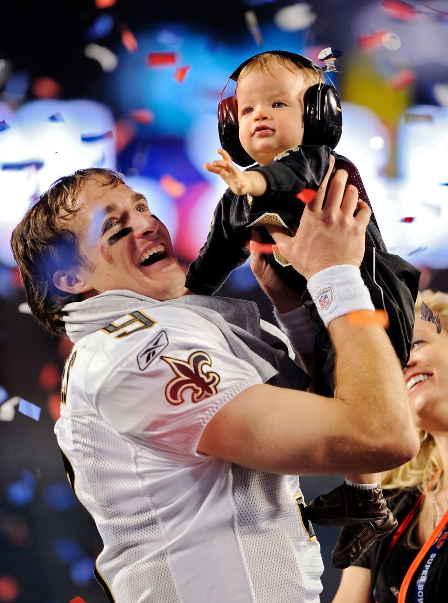 <strong>Super Bowl XLIV (2010):</strong> New Orleans Saints quarterback Drew Brees raises his son Baylen after the Saints beat Indianapolis 31-17 in Super Bowl XLIV. Brees completed 32 of 39 passes for 288 yards and two touchdowns.