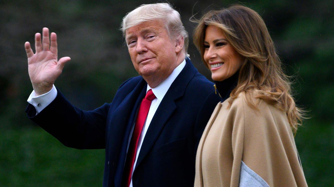 US President Donald Trump waves next to First Lady Melania Trump as they walk to Marine One before departing from the South Lawn of the White House in Washington, DC, on January 31, 2020.