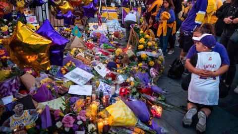 Lakers fans pay their respects at a Staples Center memorial to NBA legend Kobe Bryant, who was killed in a helicopter accident in Los Angeles, California.