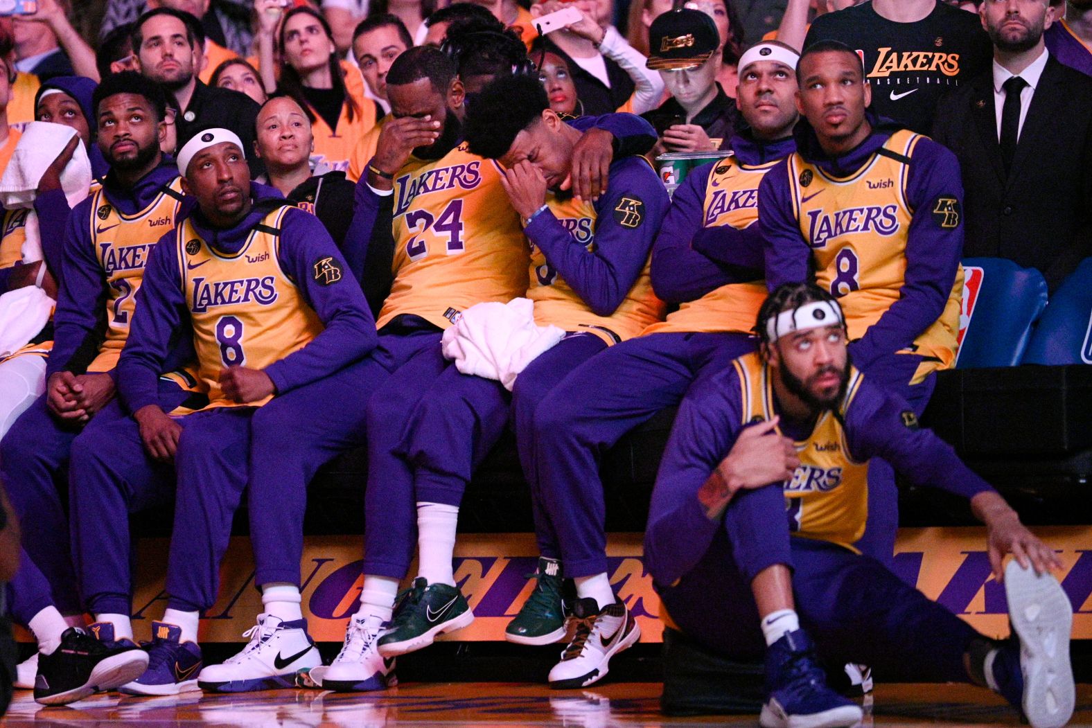 Los Angeles Lakers' LeBron James, center, and Quinn Cook react to a video tribute for Kobe Bryant, before their game against the Portland Trail Blazers on January 31.