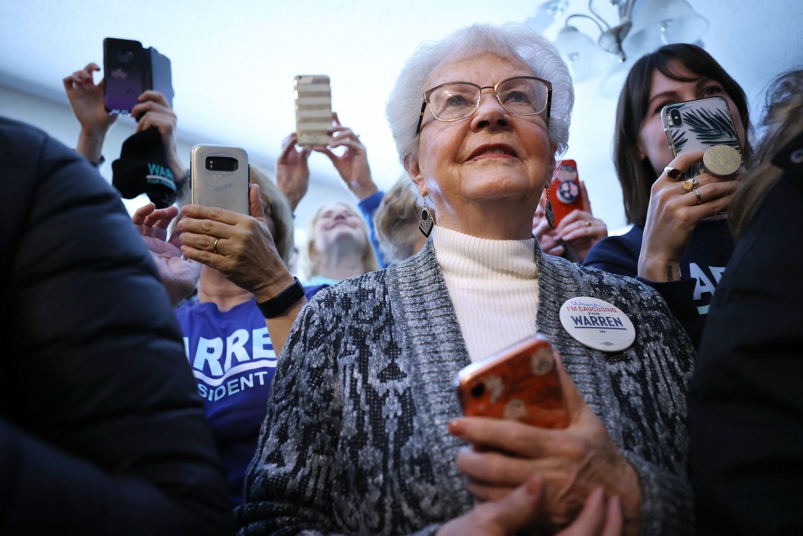 Campaign volunteers listen to Warren before going out to canvass voters in Urbandale, Iowa, on February 1.