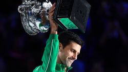 Serbia's Novak Djokovic holds up the Norman Brooks Challenge Cup trophy following his victory against Austria's Dominic Thiem in their men's singles final match on day fourteen of the Australian Open tennis tournament in Melbourne early on February 3, 2020. (Photo by William WEST / AFP) / IMAGE RESTRICTED TO EDITORIAL USE - STRICTLY NO COMMERCIAL USE (Photo by WILLIAM WEST/AFP via Getty Images)